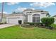 Charming single story home with brick driveway and lush landscaping at 235 Royal Palm Dr, Davenport, FL 33837