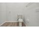Simple bathroom with toilet and wood-look floors at 235 Royal Palm Dr, Davenport, FL 33837