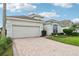 Bright, inviting home with a two-car garage and manicured lawn at 235 Royal Palm Dr, Davenport, FL 33837