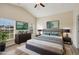 Virtually staged main bedroom with king-size bed and wood-look flooring at 235 Royal Palm Dr, Davenport, FL 33837