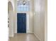 Entryway with high ceilings and blue front door at 235 Royal Palm Dr, Davenport, FL 33837