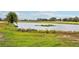 Scenic view of a lake with lush greenery and homes in the background at 235 Royal Palm Dr, Davenport, FL 33837