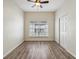 Bedroom with wood-look flooring, ceiling fan, and window coverings at 235 Royal Palm Dr, Davenport, FL 33837
