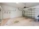 Garage with overhead door and storage shelves at 235 Royal Palm Dr, Davenport, FL 33837