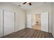 Bedroom with wood-look flooring and access to additional rooms at 235 Royal Palm Dr, Davenport, FL 33837
