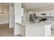 Kitchen with white cabinets, quartz countertops, and stainless steel appliances at 235 Royal Palm Dr, Davenport, FL 33837
