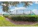 Tennis court surrounded by lush green landscaping at 235 Royal Palm Dr, Davenport, FL 33837