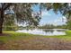 Tranquil lakefront property with oak trees and calm waters at 235 Royal Palm Dr, Davenport, FL 33837