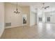 Spacious dining room with tile floors and chandelier at 235 Royal Palm Dr, Davenport, FL 33837