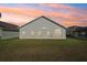 Rear view of house showcasing a large grassy yard at 235 Royal Palm Dr, Davenport, FL 33837