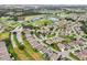 Aerial view of a residential community near a golf course and lake at 235 Royal Palm Dr, Davenport, FL 33837
