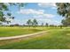 Landscaped golf course with a winding concrete path at 235 Royal Palm Dr, Davenport, FL 33837