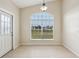 Bright breakfast nook features a large arched window and tile flooring at 235 Royal Palm Dr, Davenport, FL 33837