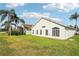 Back of house with large yard and palm trees at 235 Royal Palm Dr, Davenport, FL 33837