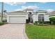 One-story home with a two-car garage and landscaped yard at 235 Royal Palm Dr, Davenport, FL 33837