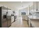 Modern kitchen with stainless steel appliances and white cabinets at 235 Royal Palm Dr, Davenport, FL 33837
