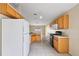 Open kitchen with wood cabinets, tile flooring, and a full suite of appliances at 2713 Sw 158Th St, Ocala, FL 34473