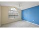 Bright bedroom with blue accent wall and tile floors at 2713 Sw 158Th St, Ocala, FL 34473