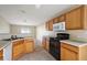 Kitchen features wood cabinets, tile floors, and a center island with a sink at 2713 Sw 158Th St, Ocala, FL 34473