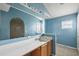 Bathroom with light blue walls, a vanity, and an oval bathtub at 2713 Sw 158Th St, Ocala, FL 34473