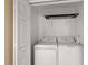 Laundry closet with washer and dryer, and overhead shelving at 2713 Sw 158Th St, Ocala, FL 34473