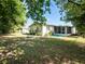 Home's back features a screened porch and grassy yard at 2816 Paine Ln, Orlando, FL 32826