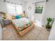 Charming bedroom with wood platform bed and colorful bedding at 2816 Paine Ln, Orlando, FL 32826