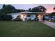 Well-maintained ranch home with a spacious lawn and carport at 2816 Paine Ln, Orlando, FL 32826