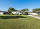 Charming ranch home with a large grassy yard and driveway at 2816 Paine Ln, Orlando, FL 32826