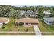 Aerial view of a brown ranch house with a backyard and surrounding houses at 3375 Sw 147Th Lane Rd, Ocala, FL 34473