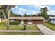 Brown ranch-style house with a well-maintained lawn and driveway at 3375 Sw 147Th Lane Rd, Ocala, FL 34473