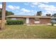 House exterior showcasing a front yard, landscaping, and a palm tree at 3375 Sw 147Th Lane Rd, Ocala, FL 34473