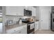 Modern kitchen featuring stainless steel appliances and light-colored cabinetry at 444 Taylor Groves Dr, Lake Wales, FL 33853