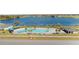 Community pool and cabana near lake, surrounded by homes at 4953 Kaia Ave, Winter Haven, FL 33884