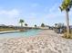 Community pool with surrounding patio and palm trees at 4953 Kaia Ave, Winter Haven, FL 33884