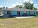 Spacious backyard, offering a concrete patio and grassy space for outdoor enjoyment at 5 Oak Trl, Ocala, FL 34472