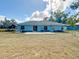 Large backyard with a patio and plenty of grassy area at 5 Oak Trl, Ocala, FL 34472