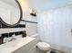 Clean bathroom with black and white tile, a shower/tub, and vanity at 5 Oak Trl, Ocala, FL 34472