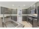 Modern kitchen with stainless steel appliances and dark gray cabinetry at 6526 Lake Pembroke Pl, Orlando, FL 32829