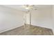 Spacious bedroom with wood-look floors and an open door to hallway at 6526 Lake Pembroke Pl, Orlando, FL 32829