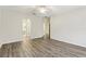 Primary bedroom with wood-look floors and access to bathroom at 6526 Lake Pembroke Pl, Orlando, FL 32829