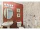 Small bathroom with pedestal sink and textured walls at 6526 Lake Pembroke Pl, Orlando, FL 32829