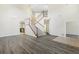 High ceiling living room with an open staircase and hardwood floors at 6526 Lake Pembroke Pl, Orlando, FL 32829