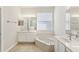 Bathroom with double vanity, soaking tub, and tile flooring at 6526 Lake Pembroke Pl, Orlando, FL 32829