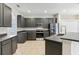 Modern kitchen with stainless steel appliances and dark gray cabinets at 6526 Lake Pembroke Pl, Orlando, FL 32829