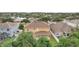 Aerial view of a two-story house with a large backyard and a neighborhood in the background at 6526 Lake Pembroke Pl, Orlando, FL 32829