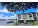 Exterior view of a condo building with a large tree and parking at 934 Lake Destiny Rd # D, Altamonte Springs, FL 32714