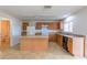 Kitchen with light wood cabinets, island, and tile flooring at 12913 Oulton Cir, Orlando, FL 32832