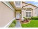 Front entrance with white door and landscaping at 14646 Brightwell Ct, Orlando, FL 32824