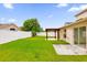Backyard with grass, pergola, and patio at 14646 Brightwell Ct, Orlando, FL 32824